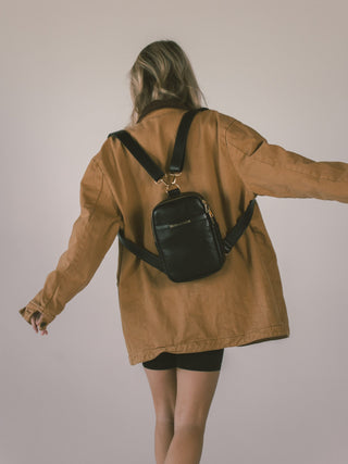 Picture of a black mini mae being worn as a backpack