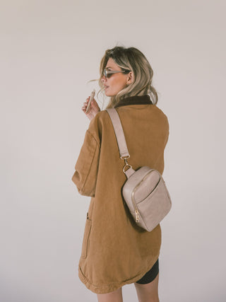 Shot of a Mauve Mini Mae being worn as a crossbody on the back